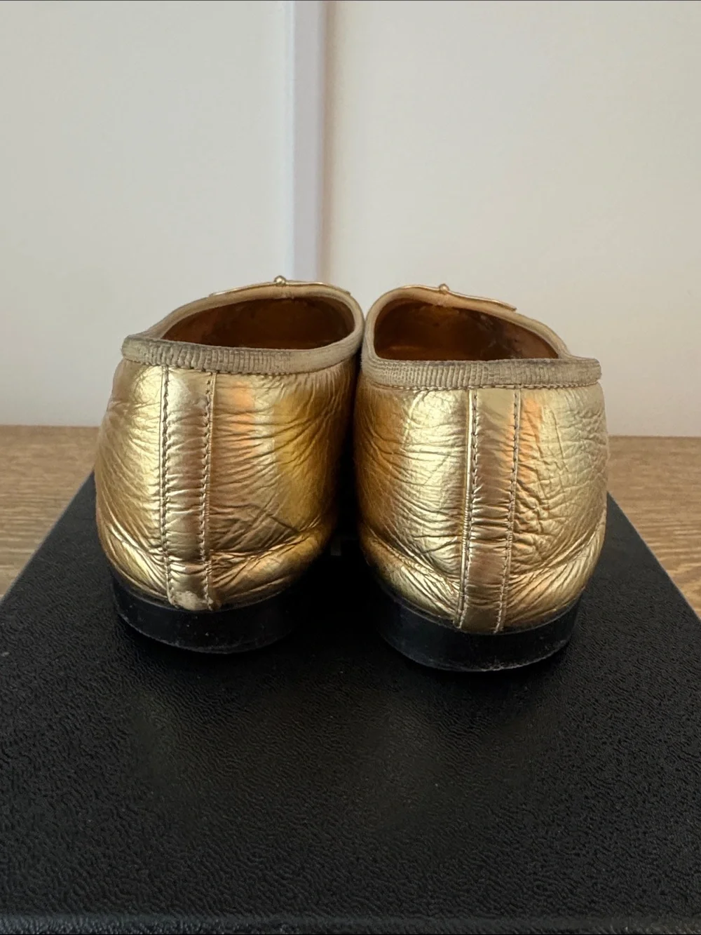 CHANEL Gold Leather Ballet Flats with Black Cap-Toe